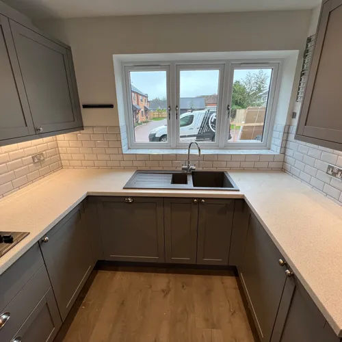 Kitchen Renovations: Example 3 photo of dark grey units and white tiles and worktop - one of the many kitchen renovations completed by Robertson Renovations.